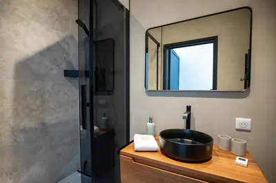 a bathroom with a black sink and a mirror at Modern 1-bedroom apartment with sea view on La Croisette in Cannes