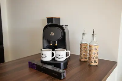 a coffee maker and two cups on a table at Modern 1-bedroom apartment with sea view on La Croisette in Cannes