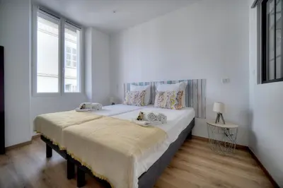 a white bedroom with a large bed with two pillows at Elégant 2 pièces TERRASSE, SUQUET-CENTRE HISTORIQUE A1B261 in Cannes