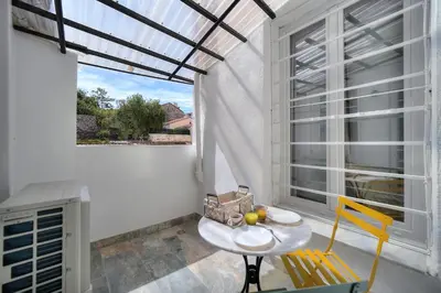 a room with a table and chairs and a window at Elégant 2 pièces TERRASSE, SUQUET-CENTRE HISTORIQUE A1B261 in Cannes