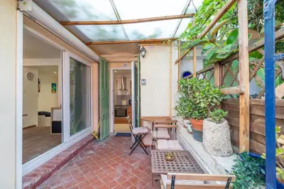a patio with a table and chairs on a house at La Succulente - T1 bis climatisé proche plage in Cannes
