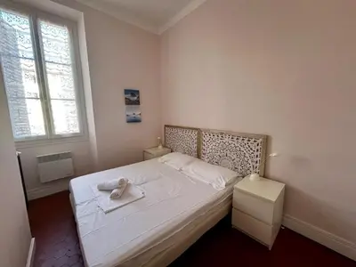 a bedroom with a bed with a towel on it at A004 - Bright apt Rue d'Antibes at 300m from beach Croisette in Cannes