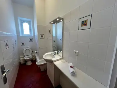 a white bathroom with a sink and a toilet at A004 - Bright apt Rue d'Antibes at 300m from beach Croisette in Cannes