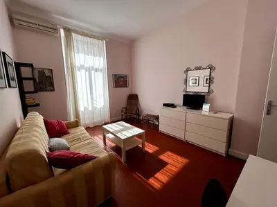 a living room with a couch and a table at A004 - Bright apt Rue d'Antibes at 300m from beach Croisette in Cannes