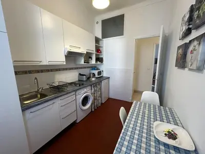 a kitchen with a sink and a washing machine at A004 - Bright apt Rue d'Antibes at 300m from beach Croisette in Cannes