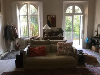 a living room with a couch and two windows at Valbois in Cannes