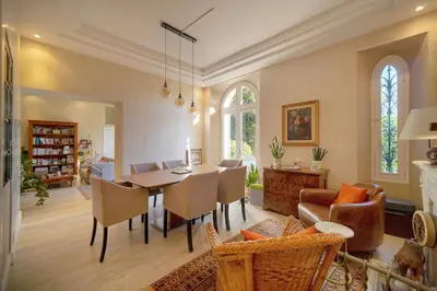 a dining room and living room with a table and chairs at Valbois in Cannes