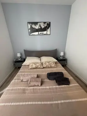 a bedroom with a large bed with pillows on it at Cocon Bohème Cannes Croisette-Palais-Plages 200m in Cannes