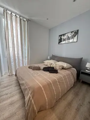 a bedroom with a large bed in a white room at Cocon Bohème Cannes Croisette-Palais-Plages 200m in Cannes