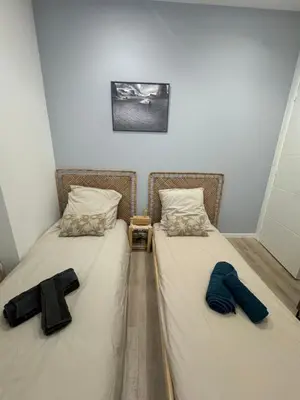 two twin beds in a small room with matching shoes at Cocon Bohème Cannes Croisette-Palais-Plages 200m in Cannes