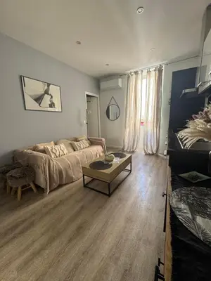 a living room with a couch and a coffee table at Cocon Bohème Cannes Croisette-Palais-Plages 200m in Cannes
