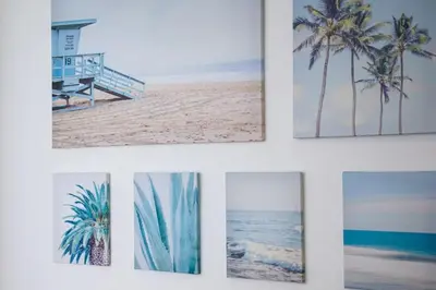 four pictures of a beach with palm trees and the ocean at Appartement familial, lumineux, calme avec parking in Cannes