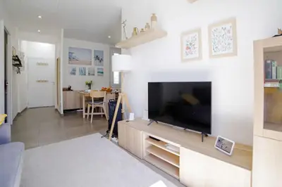 a living room with a large flat screen tv at Appartement familial, lumineux, calme avec parking in Cannes