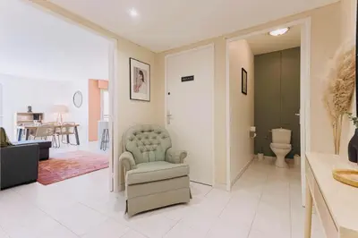 a living room with a couch and a chair at Le Calmette - Logement Confort Centre Cannes in Cannes
