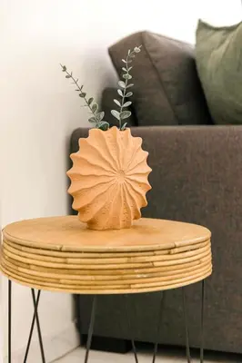 a vase sitting on top of a wooden table at Le Calmette - Logement Confort Centre Cannes in Cannes