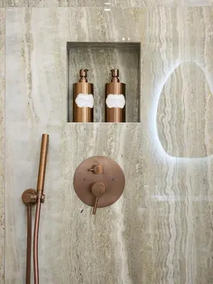 a bathroom with a mirror and two bronze thermos at Le XV Cannes in Cannes