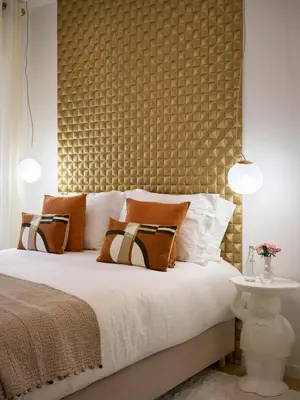 a bedroom with a large bed with a large headboard at Le XV Cannes in Cannes