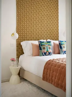 a bedroom with a large bed with a large headboard at Le XV Cannes in Cannes