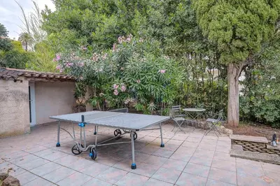 a ping pong table sitting on a patio at Villa rénovée- Vue mer- Centre de Cannes in Cannes