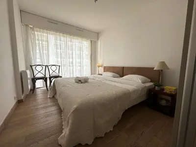 a bedroom with a large bed and a window at Charmant 2P Cannes PEL1900 in Cannes