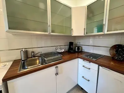 a kitchen with white cabinets and a sink at Viva Riviera Residence Rue Florian close Croisette in Cannes
