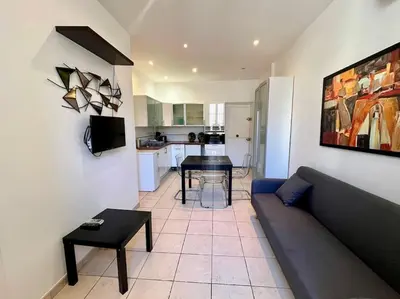 a living room with a couch and a table at Viva Riviera Residence Rue Florian close Croisette in Cannes