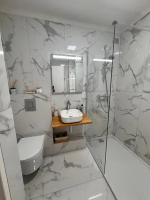a white bathroom with a sink and a shower at Парк Круазет , Апартаменты 3 комнаты , с террасой и паркингом , in Cannes