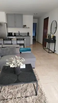 a living room with a couch and a table at Парк Круазет , Апартаменты 3 комнаты , с террасой и паркингом , in Cannes