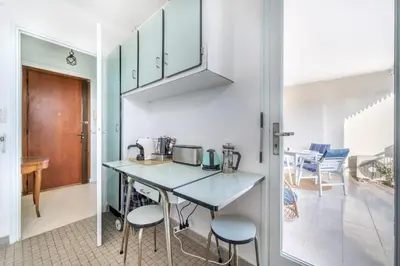 a kitchen with a table and stools in a room at A056 - Nice Studio Cannes centre with parking in Cannes