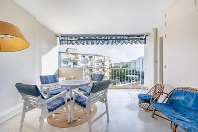 a dining room with a table and chairs and a large window at A056 - Nice Studio Cannes centre with parking in Cannes