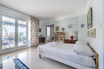 a bedroom with a large bed and a balcony at A056 - Nice Studio Cannes centre with parking in Cannes