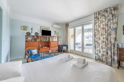 a bedroom with a large white bed and a window at A056 - Nice Studio Cannes centre with parking in Cannes