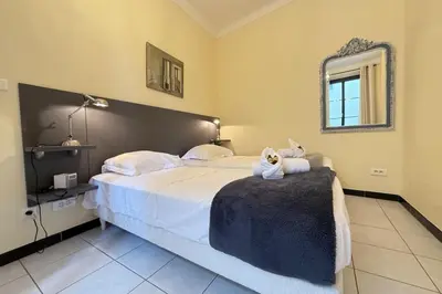 a bedroom with a bed with a teddy bear sitting on it at Beautiful 2-bedroom apartment - near the Palais and the beaches in Cannes