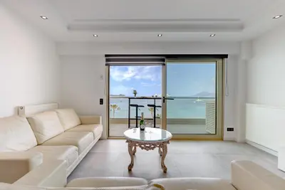 a living room with a couch and a table at Croisette sea view in Cannes