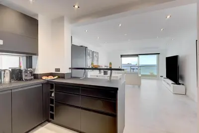 a kitchen with a counter top and a large room at Croisette sea view in Cannes