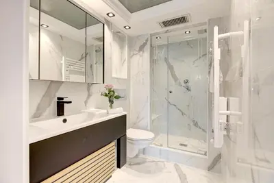 a bathroom with a shower and a toilet and a sink at Croisette sea view in Cannes