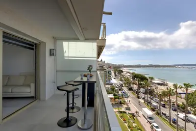 a balcony with a bar and a view of the beach at Croisette sea view in Cannes