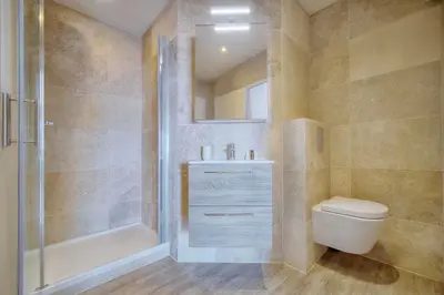 a bathroom with a toilet and a shower and a sink at Downtown Cannes 2BR with AC & Terrace w Sea View - BENAKEY in Cannes