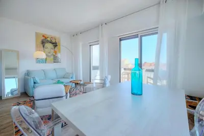 a blue bottle sitting on a table in a living room at Downtown Cannes 2BR with AC & Terrace w Sea View - BENAKEY in Cannes