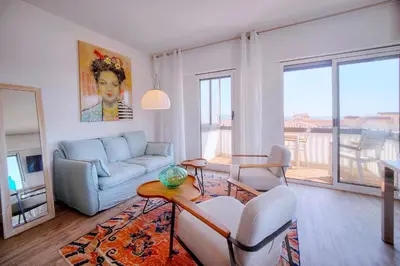 a living room with a couch and a table at Downtown Cannes 2BR with AC & Terrace w Sea View - BENAKEY in Cannes