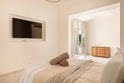 a bedroom with a bed with a television on the wall at Villa California Cannes Private Pool in Cannes