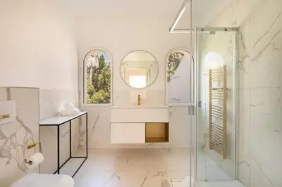 a white bathroom with a sink and a shower at Villa California Cannes Private Pool in Cannes