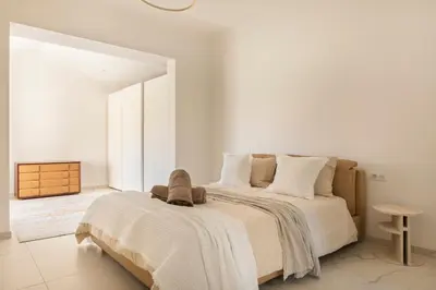a bedroom with a large bed with white walls at Villa California Cannes Private Pool in Cannes