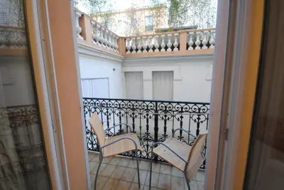 a balcony with two chairs sitting on a balcony at en centre ville magnifique pied a terre ran44 in Cannes