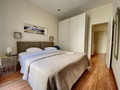 a bedroom with a large bed with white sheets at en centre ville magnifique pied a terre ran44 in Cannes
