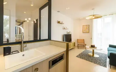 a bathroom with a sink and a blue chair at Palais Croisette Plage - 45 m2 Luxe - 2 Balcons in Cannes