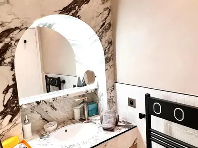 a bathroom with a sink and a mirror at Palais Croisette Plage - 45 m2 Luxe - 2 Balcons in Cannes