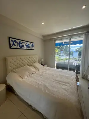 a bedroom with a large bed and a large window at Sea view Croisette in Cannes