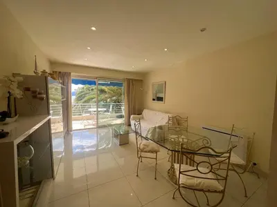 a living room with a glass table and chairs at Sea view Croisette in Cannes
