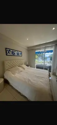 a bedroom with a large bed with a large window at Sea view Croisette in Cannes